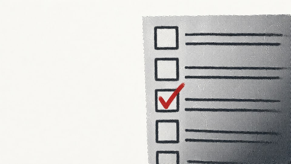 Editorial plate: a charcoal application checklist form, tilted, runs off the right and bottom of Neutral White paper. Five boxes, one Signal Red check.